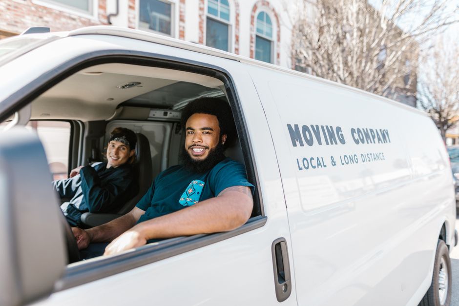 Friendly moving team carefully carrying furniture