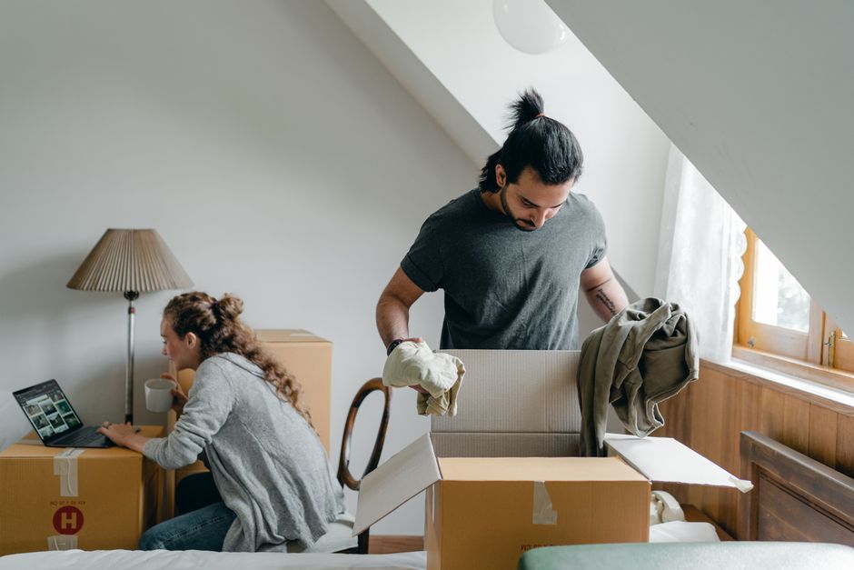 Family unpacking boxes in their new home after a long distance move